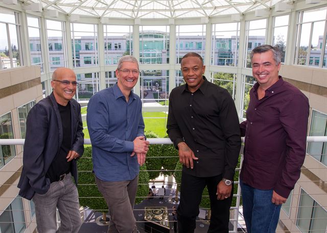 [PAP20140529070101034] In this image provided by Apple, from left to right, music entrepreneur and Beats co-founder Jimmy Iovine, Apple CEO Tim Cook, Beats co-founder Dr. Dre, and Apple senior vice president Eddy Cue pose together at Apple headquarters in Cupertino, Calif., Wednesday, May 28, 2014. Apple is striking a new chord with a $3 billion acquisition of Beats Electronics, a headphone and music streaming specialist that also brings the swagger of rapper Dr. Dre and recording impresario Jimmy Iovine. The announcement on Wednesday comes nearly three weeks after deal negotiations were leaked to the media. (AP Photo/Apple, Paul Sakuma)