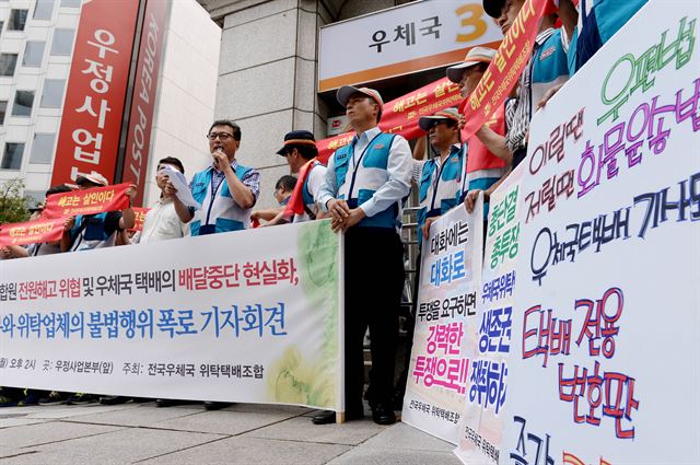 전국우체국 위탁택배조합 조합원들이 28일 서울 종로구 서린동 우정사업본부 앞에서 기자회견을 열고 위탁업체 간의 재계약 과저에서 업체의 심각한 불법 및 탈법행위가 자행되고 있고 우정사업본부와 지방청 및 우체국이 이를 묵인 방조하고 있다고 밝히고 있다. 김주성기자 poem@hk.co.kr