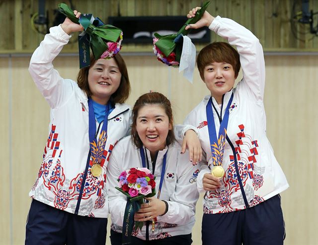 22일 아시안게임 사격 여자 25m 권총 단체전에서 금메달을 따낸 이정은, 곽정혜, 김장미(왼쪽부터)가 하트모양을 그리며 우승의 기쁨을 나누고 있다. 인천=연합뉴스