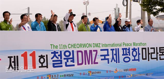 28일 강원도 철원군에서 열린 제 11회 철원 DMZ 국제 평화마라톤 출발선에서 한국일보사 이준희(왼쪽 네번째부터) 사장, 남종현 주식회사 그래미 회장, 이현종 철원군수 등 내빈들이 참가자들에게 손을 흔들며 선전을 기원하고 있다. 철원=김주성기자 poem@hk.co.kr