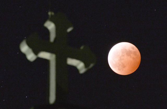 8일 일본 남부의 한 성당 옆으로 블러드문 현상이 관측되고 있다. 일본=AP 연합뉴스