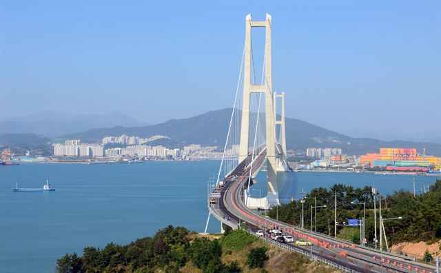 심한 흔들림 현상으로 차량 통행이 전면 통제된 이순신대교에서 27일 전문가들이 강판 균열 여부 등 주요 구조물의 손상 여부를 파악하기 위한 육안검사와 함께 실제와 비슷한 조건에서 덤프차량을 통과시키는 차량 주행시험을 벌이고 있다. 연합뉴스