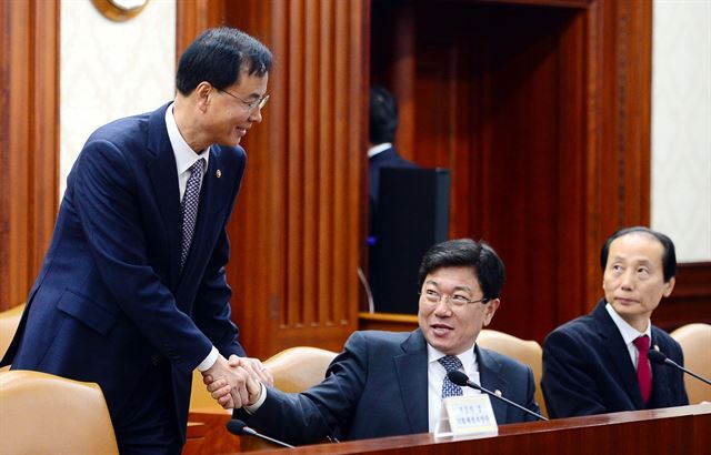 노대래 공정거래위원회 위원장과 윤상직 산업통상자원부 장관이 19일 오전 서울 종로구 정부서울청사에서 열린 경제관계장관회의에서 인사를 나누고 있다. 뉴시스