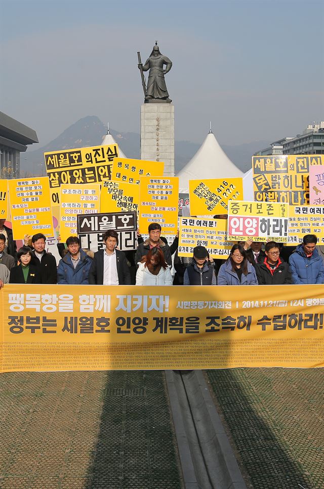 21일 오후 서울 광화문광장에서 열린 '시민 공동 기자회견'에서 세월호 참사 국민대책회의와 리멤버 0416 등 시민·사회단체 관계자들이 선체 훼손없는 세월호 인양을 촉구하고 있다. 연합뉴스