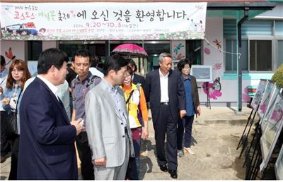 윤상기(오른쪽에서 두 번째) 경남 하동군수가 코스모스 메밀꽃 축제장인 북천역에 전시된 작품들을 둘러보고 있다. 하동군 제공