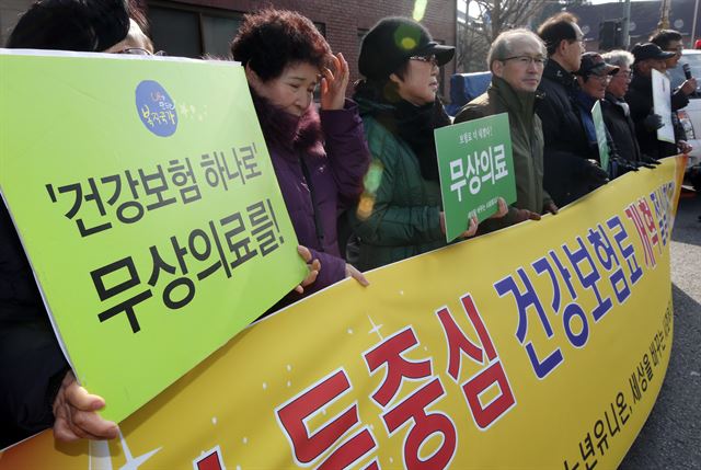 30일 오전 서울 청운효자동주민센터 앞에서 내가만드는복지국가·노년유니온 등 복지시민단체 관계자들이 정부의 건강보험료 부과체계 개편 중단을 규탄하고 재추진을 요구하고 있다. 연합뉴스