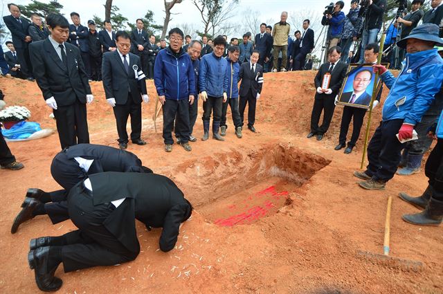 13일 오전 충남 서산시 음암면 도당리 한 야산에 자리잡은 故 성완종 전 경남기업 회장의 장지에서 유족들이 고인을 향해 마지막 절을 하고 있다. 이 장지는 성 전 회장이 평소 그리워하던 어머니의 묘 옆이다. 뉴시스