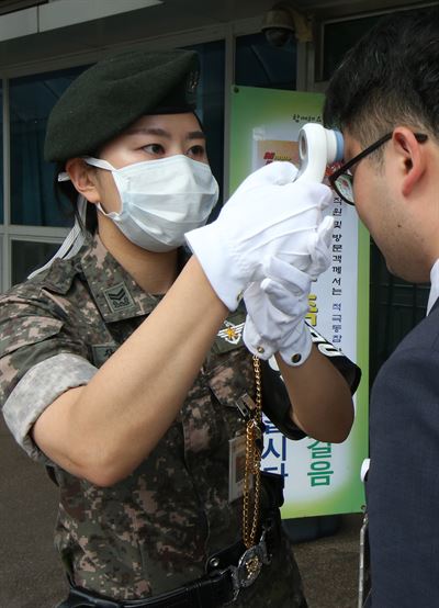 8일 서울 용산구 국방부 청사에서 헌병 간부가 출입자의 체열을 측정하고 있다. 연합뉴스