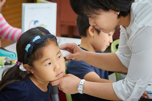 8일 오전 종로구 혜화초등학교 1학년 교실에서 담임 선생님이 어린이들의 체온을 재고 있다. 중동호흡기증후군(메르스) 확산이 계속되고 있는 가운데 서울시교육청은 강남구와 서초구의 유치원 69개, 초등학교 57개 등 126곳이 이날부터 10일까지 일괄휴업한다고 밝히면서 이외 정상적으로 운영되는 학교에게 등교한 학생 전체에 대해 매일같이 발열체크를 할 것을 당부했다. 황재성 기자 goodluck@snhk.co.kr