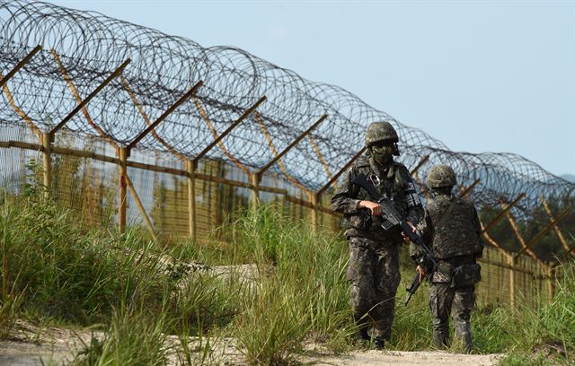 지난 4일 비무장지대(DMZ)에서 발생한 지뢰폭발사고 현장 주변에서 9일 장병들이 무장한 채 수색작전을 하고 있다. 국방부 제공