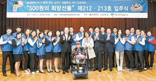 삼성화재 설계사들의 사회공헌활동인 ‘500원의 희망선물’ 제 212, 213호 입주식을 기념해 212호 수혜자 윤혜정씨와 설계사들이 경기 수원시장애인종합복지관 강당에서 기념촬영을 하고 있다. 삼성화재 제공