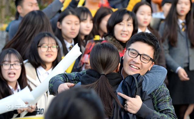 2016학년도 대학수학능력시험이 치러진 12일 오전 서울 종로구 안국동에 위치한 풍문여고를 찾은 수험생들의 담당교사가 고사장으로 들어서는 제자들을 안아주고 있다. 서재훈기자 spring@hankookilbo.com