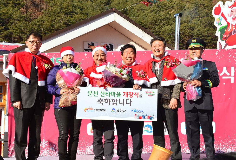 우병윤(왼쪽에서 4번째) 경북도 정무실장과 박노욱(5번째) 봉화군수 등이 지난 19일 경북 봉화군 분천역 산타마을 개장식에서 분천역장과 관광객 등에게 축하 꽃다발을 증정하고 환히 웃고 있다. 경북도 제공/2015-12-20(한국일보)