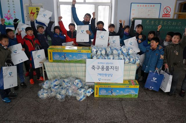 축구사랑나눔재단은 18일 중국 헤이룽장성 하이린시에 있는 조선족 실험소학교 축구부 학생들을 위해 축구화와 축구공, 미니골대 등 700만원 상당의 축구용품을 전달했다. 사진은 학생들이 축구용품을 받고 기뻐하는 모습. 축구사랑나눔재단 제공