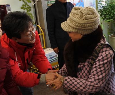 대구 동구을 지역에서 4선에 도전하는 유승민 새누리당 의원이 2일 오후 선거구인 공산동 팔공새마을금고를 찾은 주민의 손을 잡고 인사하고 있다. 대구=배유미기자 yum@hankookilbo.com