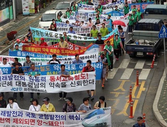 전국에서 유일하게 4차선 광역 연결도로와 철도가 닿지 않는 강원 화천군이 교통여건 개선을 위해 목소리를 높이고 있다. 화천지역 시민사회단체 회원들이 지난 2014년 동서고속화철도 화천역 설치를 요구하는 촉구대회를 마친 뒤 가두행진을 벌이고 있다. 연합뉴스