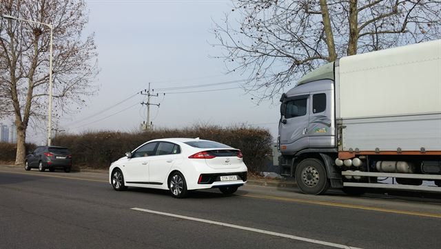 현대자동차의 친환경전용모델 아이오닉 하이브리드가 도로를 달리고 있다. 황량한 풍경이 중국 같지만 자유로다.