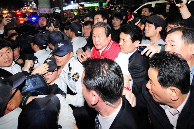 김무성 새누리당 대표가 30일 대구 수성구 새누리당 대구시당에서 열린 선거대책위원회 회의를 마친 뒤 경찰의 호위를 받으며 빠져나가고 있다. 대구 동구을 무공천으로 출마길이 막힌 이재만 전 동구청장 지지자들의 격렬한 시위로 김 대표는 시당 옆의 대구은행을 통해 입장했으며, 퇴장 때에는 이들이 길을 막는 바람에 5분 가량 갇혀 있기도 했다. 대구=뉴시스