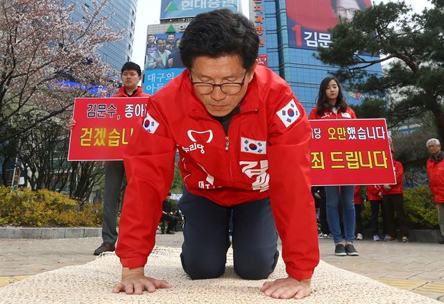 김문수(수성갑) 새누리당 후보가 6일 오후 대구 수성구 범어네거리에 있는 자신의 선거사무소 앞에서 '새누리당의 오만함을 사죄드린다'는 피켓을 세워두고 시민들에게 절을 하며 용서를 구하고 있다. 대구=연합뉴스