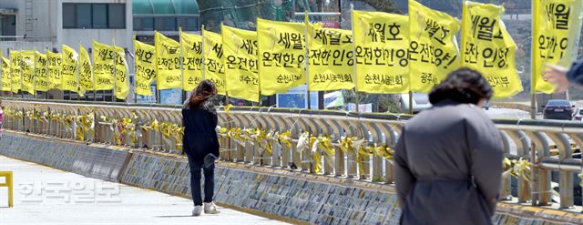 [세25] [저작권 한국일보]세월호 참사 2주기를 하루 앞둔 15일 오후 전남 진도 팽목항 방파제를 찾은 시민들의 희생자들을 추모하는 글을 읽고 있다. 진도= 서재훈기자 spring@hankookilbo.com