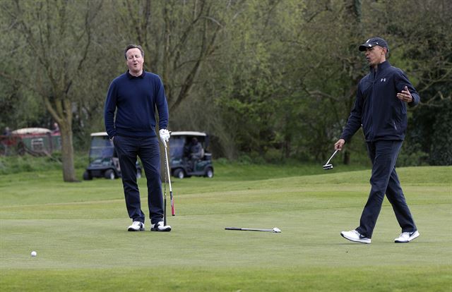 President Barack Obama and Britain's Prime Minister David Cameron react to the president missing a put on the third green at the Grove Golf Course in Hertfordshire, England, Saturday, April 23, 2016. (AP Photo/Carolyn Kaster)