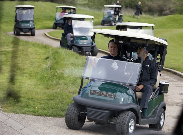 President Barack Obama and Britain's Prime Minister David Cameron ride in their cart from third green at the Grove Golf Course in Hertfordshire, England, Saturday, April 23, 2016. (AP Photo/Carolyn Kaster)