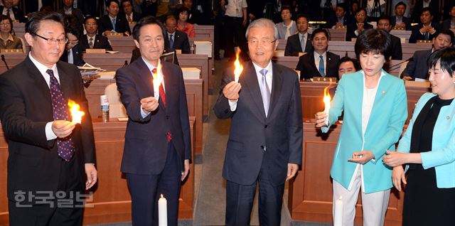 더불어민주당 김종인 비상대책위 대표(가운데)와 우상호 원내대표가 30일 오전 국회에서 열린 제20대 국회 첫 의원총회에서 부실채권을 소각하는 퍼포먼스를 하고 있다. 배우한 기자 bwh3140@hankookilbo.com