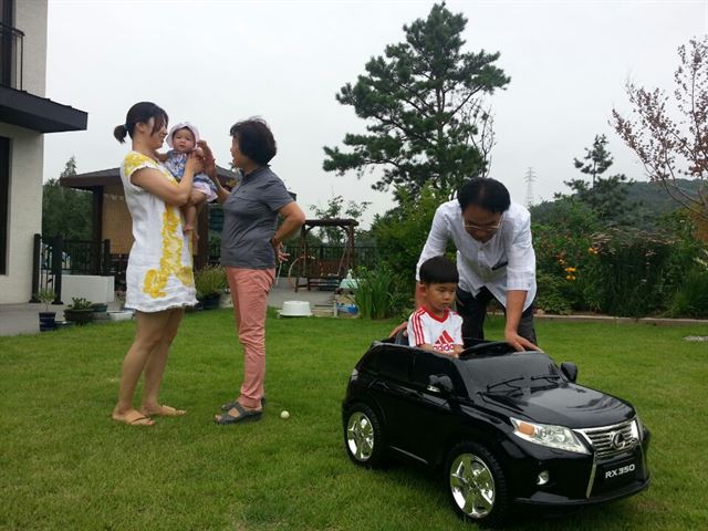 경기 용인시 처인구에 전원주택을 지어 아들 부부와 함께 살고 있는 김명권씨 가족이 잔디 마당에서 단란한 시간을 보내고 있다.