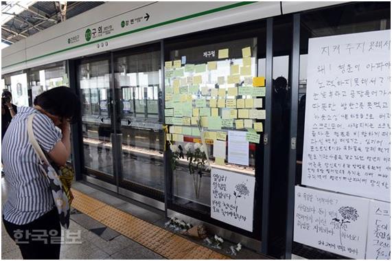 지난 5월 31일 서울 지하철 2호선 구의역 스크린도어 수리 작업 중 사고로 숨진 김모(19)군을 추모하는 국화꽃과 메모 앞에서 한 시민이 눈물을 흘리고 있다. 한국일보 자료사진