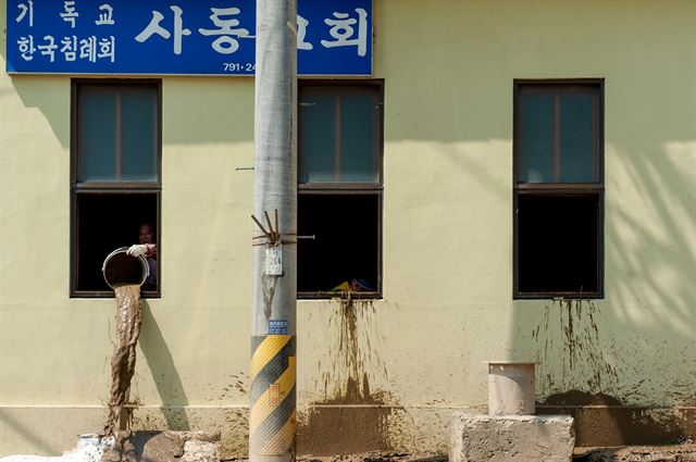 1일 피해 복구에 나선 경북 울릉도 주민들이 울릉읍 사동리 사동교회에서 양동이로 흙탕물을 퍼내고 있다. 울릉군 페이스북.