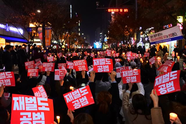 19일 오후 박근혜퇴진 3차 시국대회가 열린 대구 중구 대중교통전용지구에서 대구시민들이 '재벌도 공범' 카드를 들고 박근혜 퇴진을 외치고 있다. 윤희정기자 yuni@hankookilbo.com