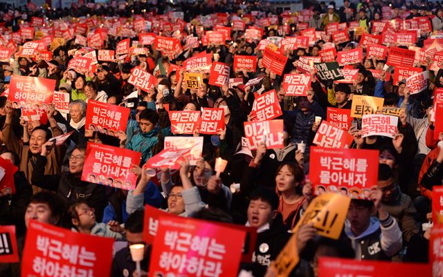 제4차 대통령 하야촉구 집회가 열린 19일 광화문광장에서 시민들이 피켓을 들어 구호를 외치고 있다.오대근기자 inliner@hankokilbo.com