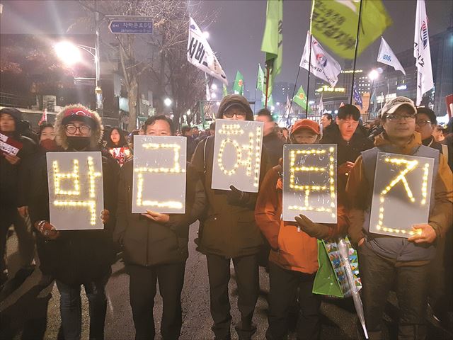 노동조합 활동가인 신재용(왼쪽 첫번째)씨는 '모두가 함께 잘 사는 세상'을 꿈꾸며 거리로 나온다. 26일 오후 서울 광화문광장 인근에서 신씨와 동료들이 박근혜 대통령 퇴진을 요구하는 피켓을 들고 있다. 정반석 기자