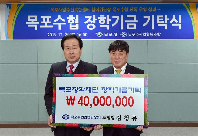 26일 목포시청 시장실에서 목포수협 김청용(오른쪽)조합장이 목포장학재단에 4,000만원을 기탁했다.