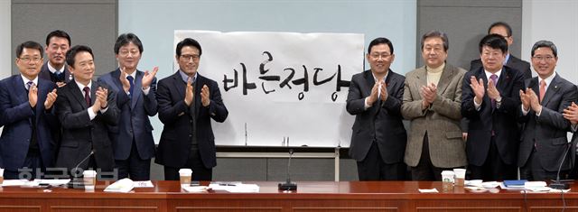 8일 오전 서울 여의도 국회 의원회관에서 열린 '개혁보수신당(가칭) 당명채택회의'에서 김무성, 유승민 의원을 비롯한 참석자들이 공식적으로 결정된 '바른정당' 글씨 앞에서 박수를 치고 있다. 서재훈기자