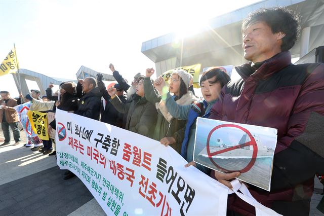 7일 오전 서귀포시 강정동 제주해군기지 정문 앞에서 열린 '줌월트 제주해군기지 배치 논의에 대한 입장발표 기자회견'에 참가한 강정마을 주민과 제주해군기지 전국대책회의 관계자들이 구호를 외치고 있다. 연합뉴스.