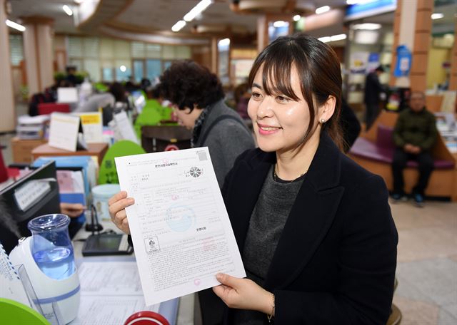 문경시 민원실에서 본인 서명으로 확인서를 뗀 한 시민이 본인서명사실확인서를 발급받아 확인하고 있다. 문경시 제공