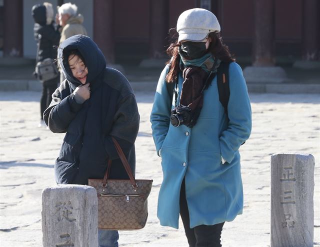 서울 최저기온 영하 4도를 기록한 6일 오전 서울 경복궁에서 외국인 관광객들이 발걸음을 재촉하고 있다. 연합뉴스