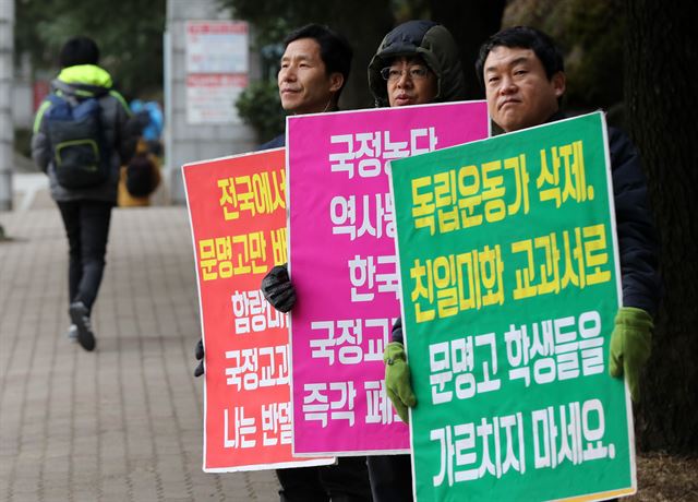 문명고등학교 정문 앞에서 학교 인근 주민들이 국정교과서 채택에 반대하는 내용의 피켓을 들고 있다. 연합뉴스