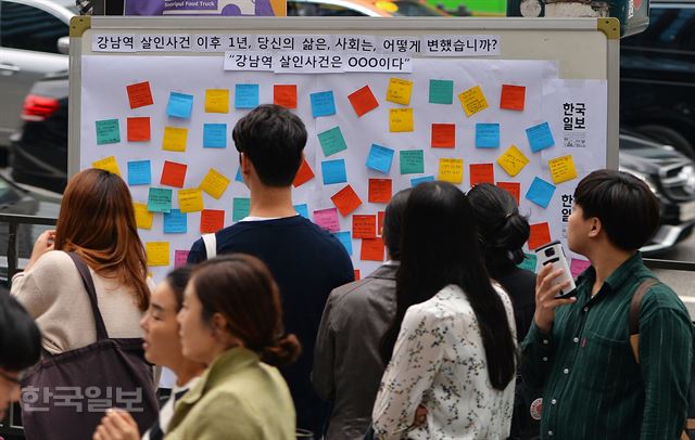 한국일보가 ‘강남역 살인사건 1주기’를 앞두고 지난 12일 서울 강남역 10번 출구 앞에 차린 부스에서 시민들이 우리 사회 여성혐오에 대한 문제의식을 포스트잇에 자유롭게 담고 있다. 류효진 기자