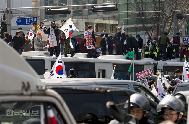 박근혜 전 대통령의 파면이 결정된 3월 10일 서울 안국역 일대에서 벌어진 ‘태극기 집회’ 참석자들이 헌법재판소로 진출하기 위해 경찰 버스에 오르고 있다. 류효진기자 jsknight@hankookilbo.com