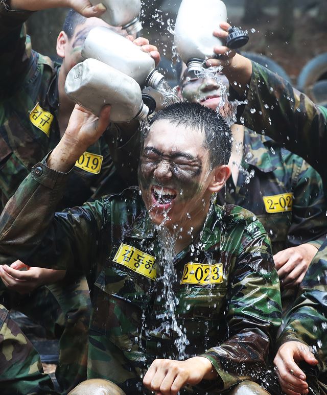 폭염이 계속되고 있는 19일 오전 경기도 용인시 육군 55사단 신병교육대에서 각개전투 훈련을 마친 훈련병들이 수통의 물을 서로에게 뿌려주며 더위를 식히고 있다. 55사단 신병교육대대는 혹서기에 온도지수를 고려하여 훈련의 시간과 강도를 조절함으로써 무더위를 효과적으로 극복하는 실전적 훈련에 매진하고 있다고 밝혔다. 2017.7.19 용인=연합뉴스