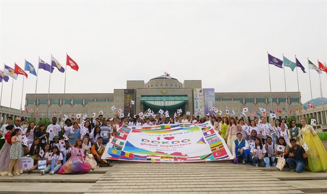 독도재단이 주최한 '독도 글로벌라이징' 선포식에 참석한 외국인 유학생들이 22일 서울 용산전쟁기념관 앞에서 대형 독도사랑 현수막과 태극기를 들고 기념촬영을 하고 있다. 독도재단 제공