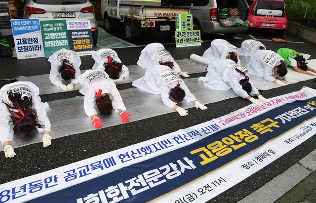 고용안정 보장하고 무기계약전환을 요구 하는 전국 영어회화전문강사들이 28일 오전 서울 청운동사무소 앞에서 해고는 살인이란 의미로 소복을 을 입고 고용안정을 촉구 하는 108배를 하고 있다. 신상순 선임기자ssshin@hankookilbo.com /2017-07-28(한국일보)