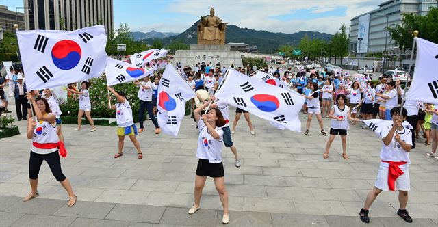 15일 오전 서울 광화문 광장에서 세계국학원청년단 단원들이 광복 68주년 8·15 태극기 플래시몹을 펼치고 있다. 뉴시스