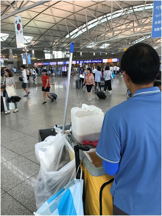 14일 인천국제공항 출국장에서 한 환경미화 노동자가 일회용 컵 등에서 나오는 음료 등을 모아두는 플라스틱 통이 올려져 있는 카트를 밀고 있다.