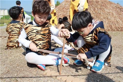 선사문화축제에서 불 피우기 체험을 하는 어린이들. 강동구 제공