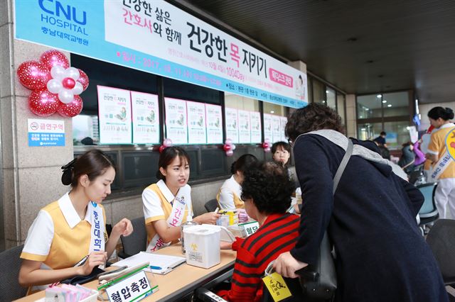 충남대병원 간호사들이 본관 입구에서 '건강한 목 지키기'를 주제로 운동요법 교육, 혈압.혈당 측정, 건강상담 등 봉사활동을 펼치고 있다. 충남대병원 제공