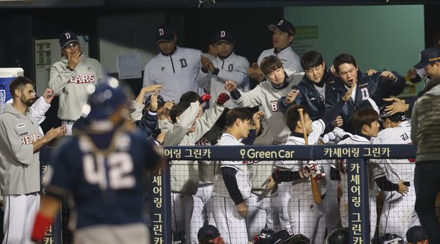 두산 김재환이 3회말 동점 3점 홈런을 치고 더그아웃에서 동료들로부터 축하를 받고 있다. 연합뉴스