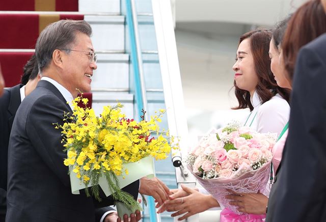 인도네시아 국빈 방문을 마친 문재인 대통령 내외가 10일 '아시아태평양경제협력체(APEC)' 정상회의에 참석하기 위해 베트남 다낭 국제공항에 도착해 꽃다발을 건네받고 있다. 다낭=연합뉴스